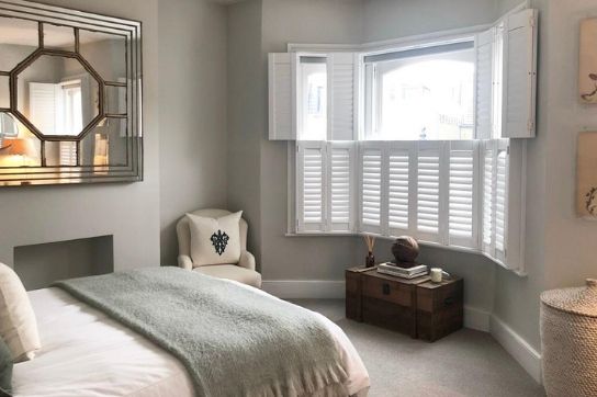bedroom with tier on tier shutters, bottom closed and top open