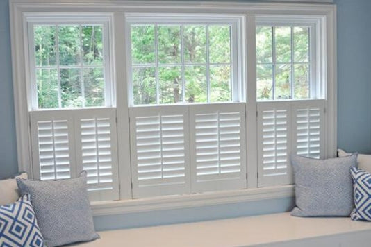 white shutters in cafe style and sofa with cushions matching the wall grey colour