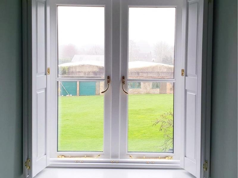 open shutters on a window showing the Oxfordshire countryside