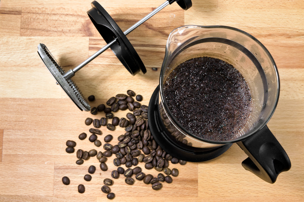 Whole bean coffee and a french press.