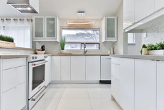 An all white kitchen with modern cabinet hinges