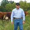 Dr. Allen Williams Ph.D. standing on farm