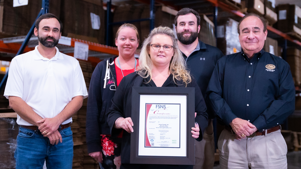 Joyce Farms employees holding certificate of BRC Food Safety certification BRCGS