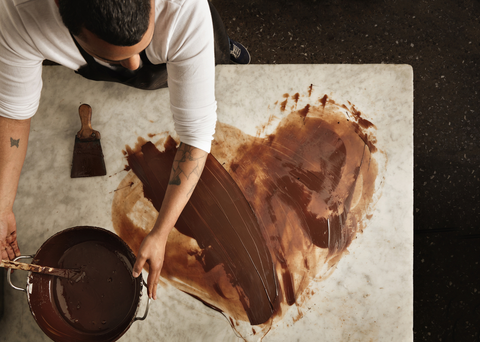 Man tempering chocolate