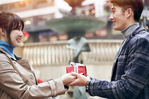 Woman receiving chocolate from her boyfriend on Valentine's Day