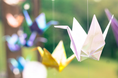 Colorful Japanese origami paper tsuru in the air