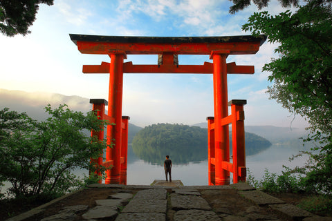 tourlist at red Torii gate of Hakone shrine located on lake Ashi, Japan.