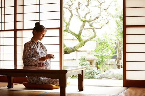 A young woman is relaxing at a traditional Japanese inn