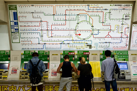Passengers are buying tickets from vending machines inside Tokyo Station and train Map