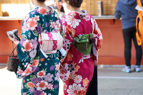 Young girls wearing Japanese kimono standing in front of Sensoji Temple in Tokyo, Japan