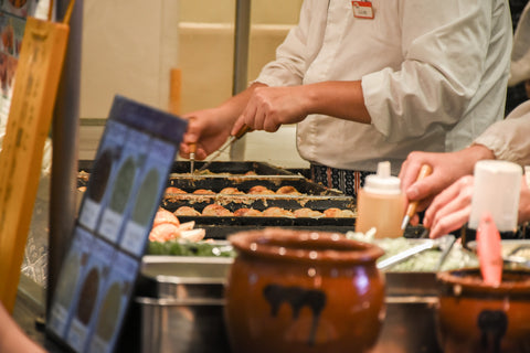 Chef Cooking Takoyaki At Shop In Food Court