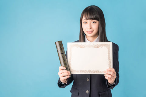 Japanese school girl holding a testimonial.