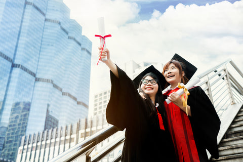 Asian students wearing a graduation ceremony. smile happily and hold graduation certificate.