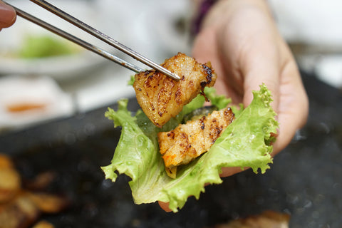 Samgyeopsal pork belly in a lettuce wrap