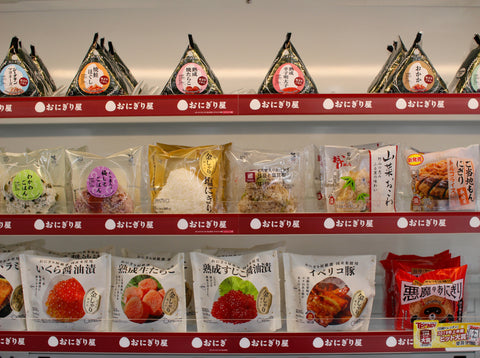 Different kinds of rice balls on a shelf at a Japanese convenience store