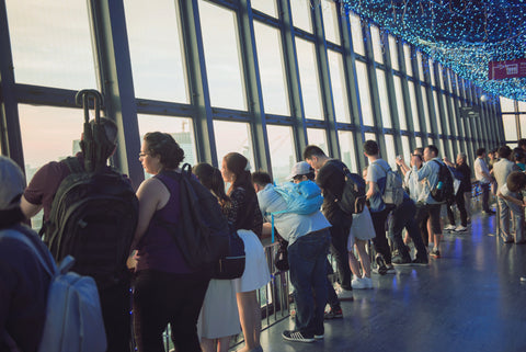 Tourists at the Tokyo Tower observing the Tokyo cityscape in the main observatory.