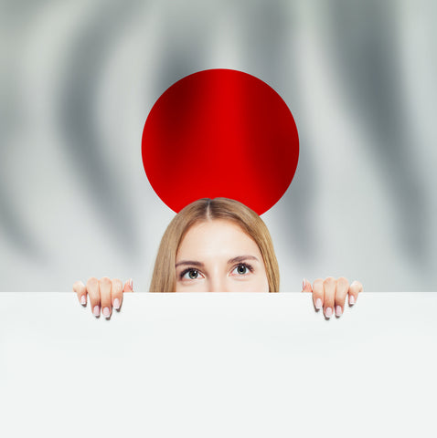 Young woman with white banner on Japanese flag background