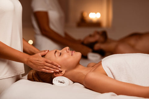 Date In Spa. Couple Enjoying Head Massage Together Relaxing Lying On Beds With Eyes Closed In Beauty Salon Indoor, While Masseuse Massaging Body.