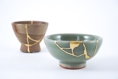 Japanese sake cups set, Kintsugi gold cracks, antique Japanese restoration technique.