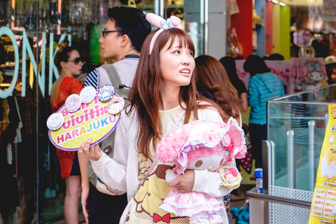 Cute (kawaii) Japanese young girl promoting a fashion store and tourists at side streets in Harajuku