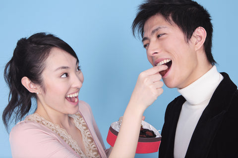 Couple feeding each other chocolates