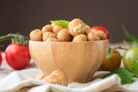 Traditional Japanese peanuts have a sweet, salty, umami flavor, while regular roasted peanuts are often kept simple with a sprinkle of salt.
