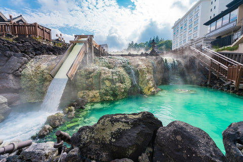 Scenery of Yubatake in Kusatsu Onsen, wooden buildings in the background