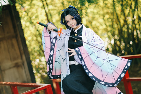 Portrait of a girl with a Demon Slayer character costume in the Japanese theme garden. Individual cosplayers