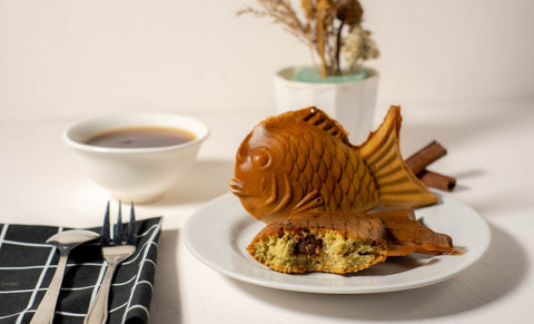 Traditional Japanese dessert Tayaki. Sweet waffles in the form of fish with red bean fillings