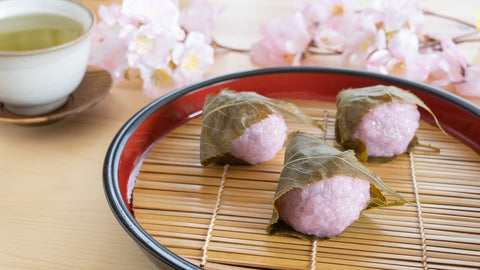 Japanese spring sweets. Green tea and sakura mochi.