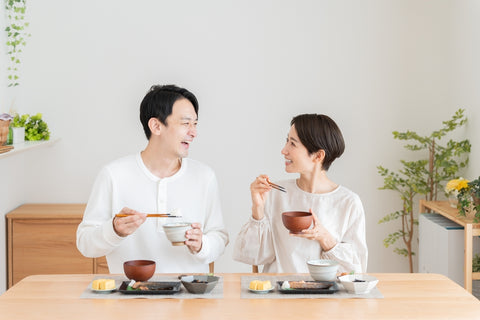 Japanese couple eating a typical Japanese breakfast
