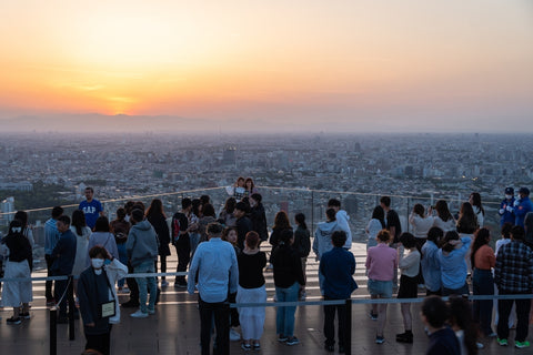 People enjoy the sunset over Tokyo cityscape from the Shibuya Sky observation desk in Japan capital city.