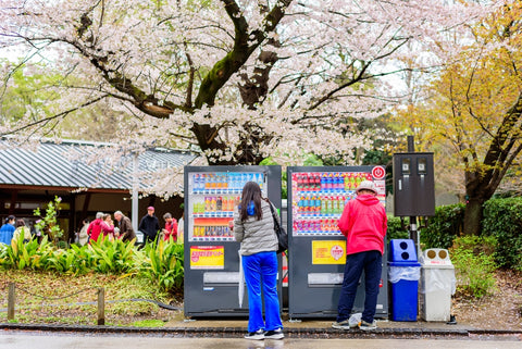 People using drink vending machines at Ueno park, Japan