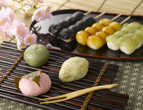 Traditional Japanese sweets on the black tray with cherry blossom