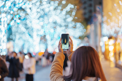 Traveler visiting Roppongi Hills Christmas Illumination and taking photo Tokyo Tower in Minato City