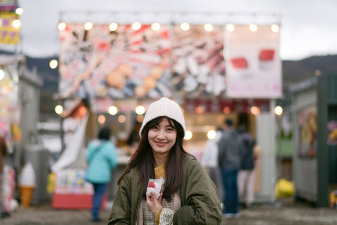 Japanese traveler enjoys a tasty strawberry treat in Tokyo during festival
