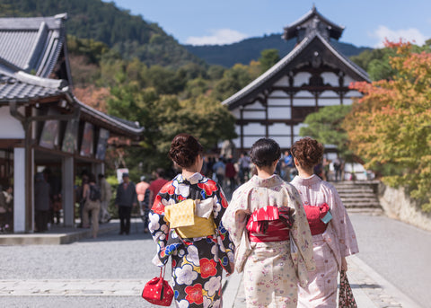 Japanese women in kimonos are walking to Tenryu-ji Temple in Kyoto, Japan