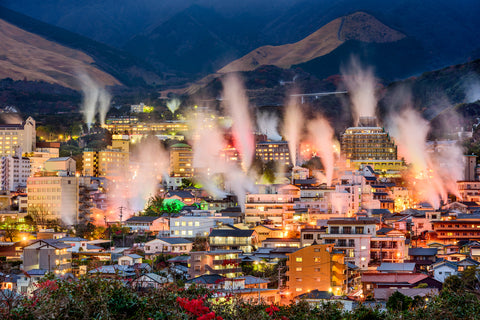 Beppu, Japan cityscape with hot spring bath houses and rising steam. (traditional Japanese inns)