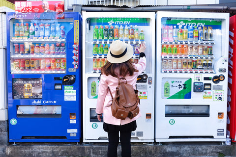 Japan Tourist is selecting soft drink at vending machine in Tokyo, Japan.