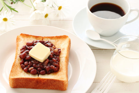 Toast with Japanese Azuki bean paste and Butter on white plate. Typical Japanese Breakfast set in Nagoya