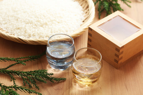 Japanese Sake served in glass cup and traditional wooden cup