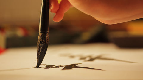 Calligraphy brush writing Japanese letter on paper