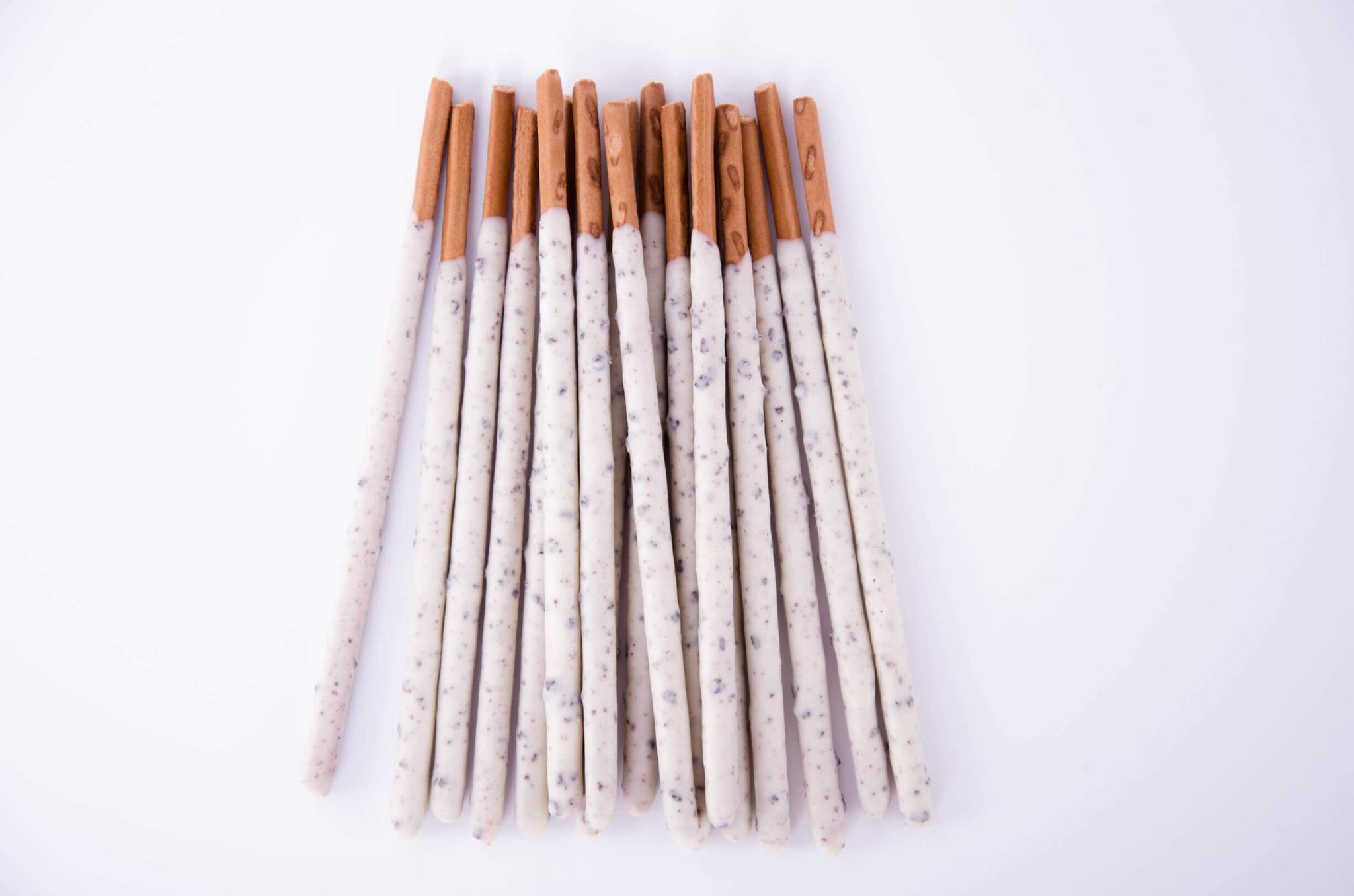 The unique Japanese Pocky flavor of traditional biscuit and chocolate dipping are elevated with a layer of coconut flakes