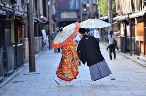 Couple walking the street in Kyoto with traditional kimono