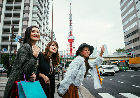 Group of Japanese women spending time in Tokyo, making shopping in different areas of the city