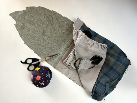 An in-progress Satchel is shown, with the assembled Satchel Front being pinned to a Leaf Satchel flap and back.