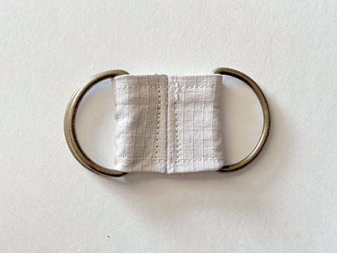 The Loop piece is shown in the same flat orientation as the previous step, with topstitching added down either side of the seam where it lays in the center.
