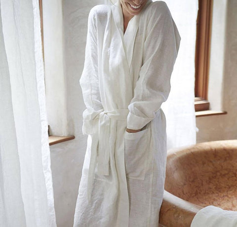 A lady smiling wearing a bathrobe after shower