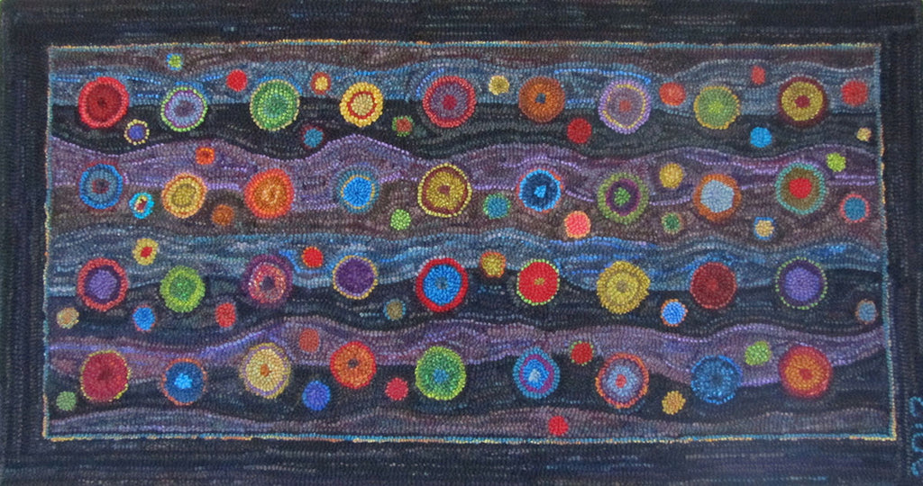 Bubble Rug. Designed and Punched by Sandra Marshall, Santiago, Chile. 29" x 52". Before Sandra finished her rug she emailed the following note about her work in progress saying, "It is using up a lot of my handspun wool and I am enjoying punching it while I watch the Olympics. This is also a "feel good" rug because it is using up lots of odds and ends of rug yarn. I based the design on wool penny rugs but my husband has named it the "bubble rug" and the name has stuck." 