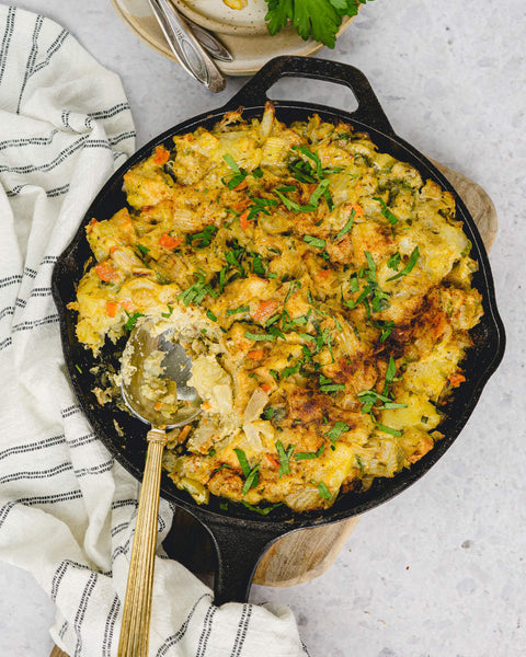 Mashed Potato Stuffing Casserole (Gluten-Free, Dairy-Free) in a cast iron skillet on the counter